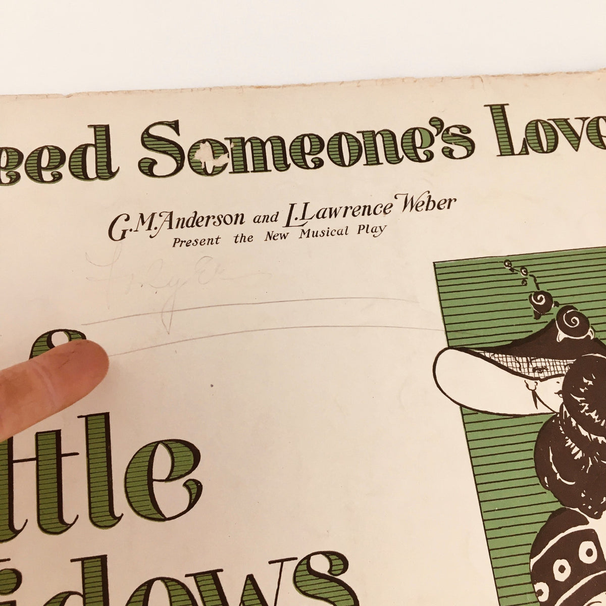 Close-up of the cover of the vintage magazine 'I Need Someone's Love', highlighting the title 'His Little Widows' and showing handwritten notes that add character to the historical piece.