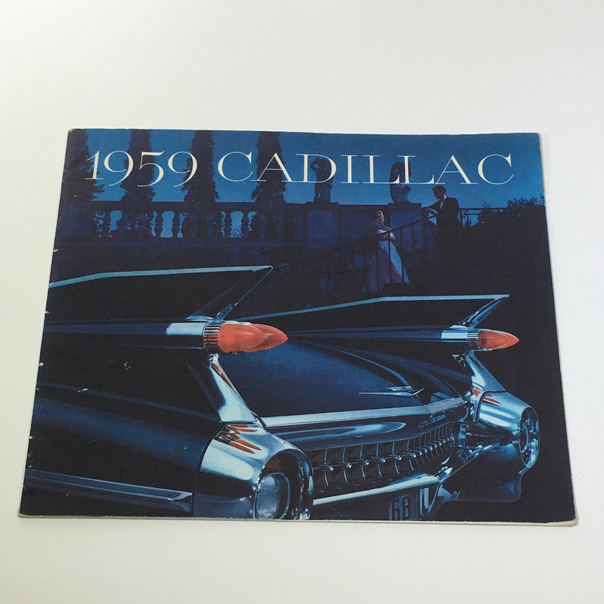 1959 Cadillac Fleetwood Sixty Special Sedan V-Type Engine Car Sale Brochure cover featuring a stylish car design with prominent tail fins and a night setting.