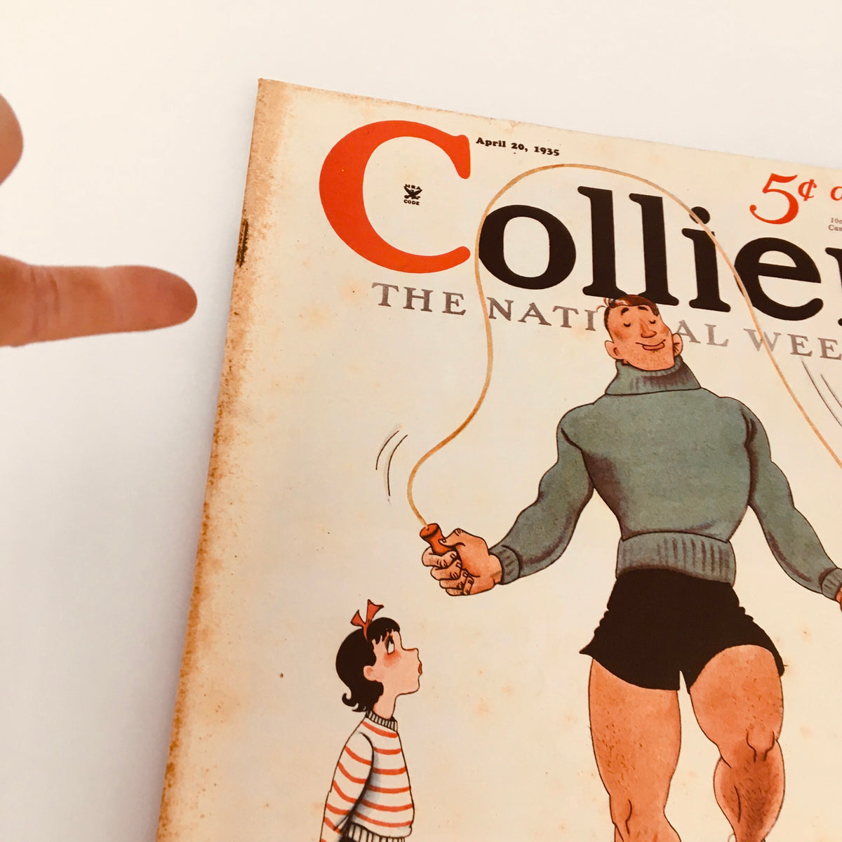 Close-up view of the cover of Collier's Magazine from April 20, 1935, titled 'The Little Schoolhouse by Walter Davenport', highlighting the artwork of a muscular man skipping rope with children in a classic vintage style.