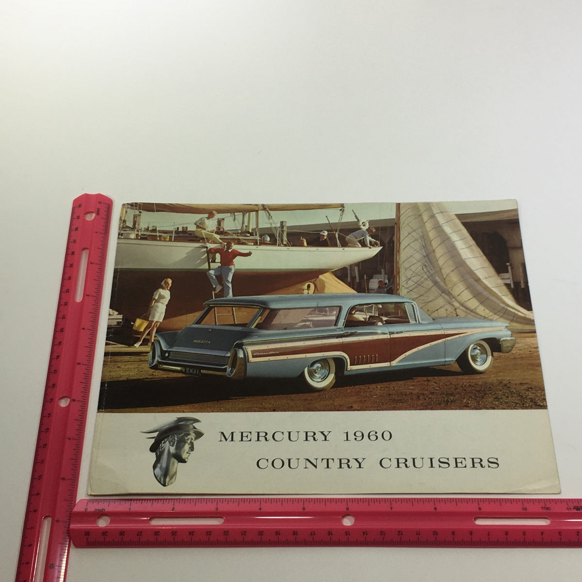 Front cover of the 1960 Mercury Country Cruisers Self-Adjusting Brakes Hydraulics Car Sale Brochure with a classic car display on a scenic location.