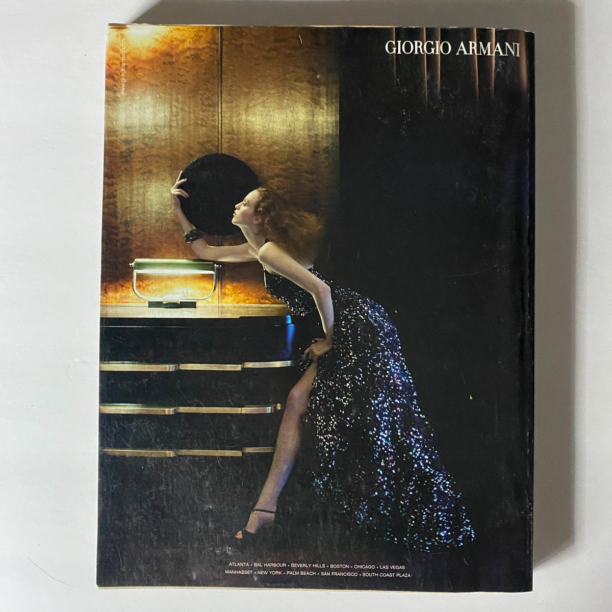 Back cover of the W Magazine March 2005 issue featuring a dramatic advertisement of a model in a glamorous Giorgio Armani dress, highlighting the luxurious fashion of the early 2000s.