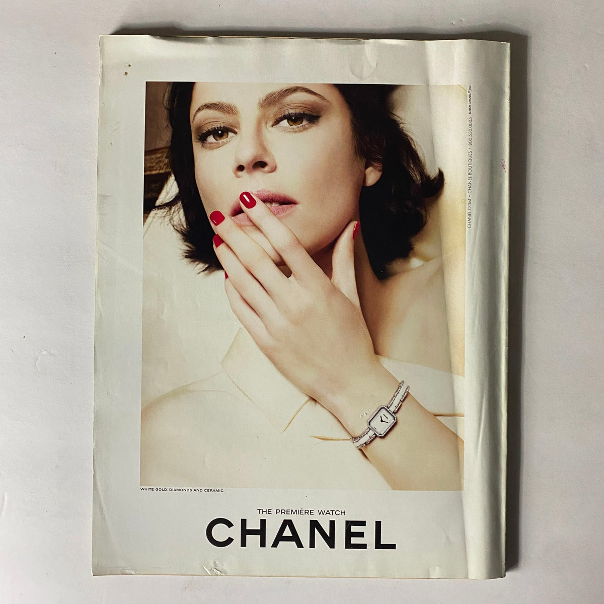 Chanel advertisement featuring a woman elegantly wearing The Premiere Watch, highlighted by striking red nails, embodying luxury and sophistication.