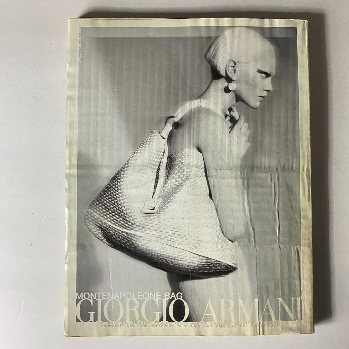 W Magazine March 2009 cover image of a black and white advertisement for a Giorgio Armani bag, emphasizing luxury fashion aesthetics.
