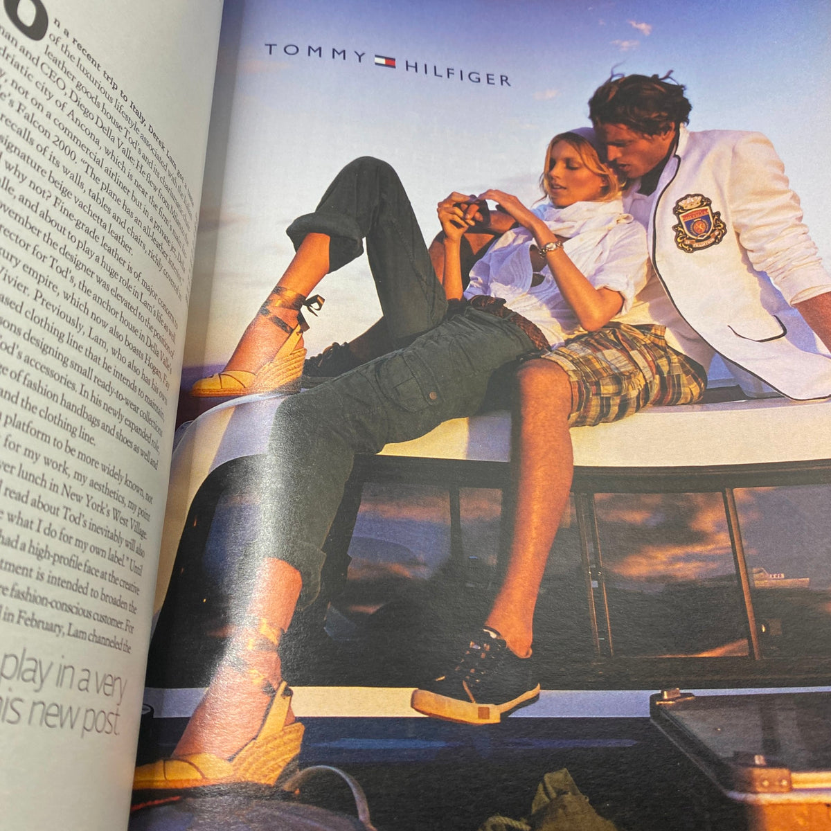 W Magazine April 2007 issue featuring a Tommy Hilfiger advertisement, showcasing a couple stylishly posing on a car with an elegant sunset backdrop. Perfect representation of mid-2000s fashion and culture.
