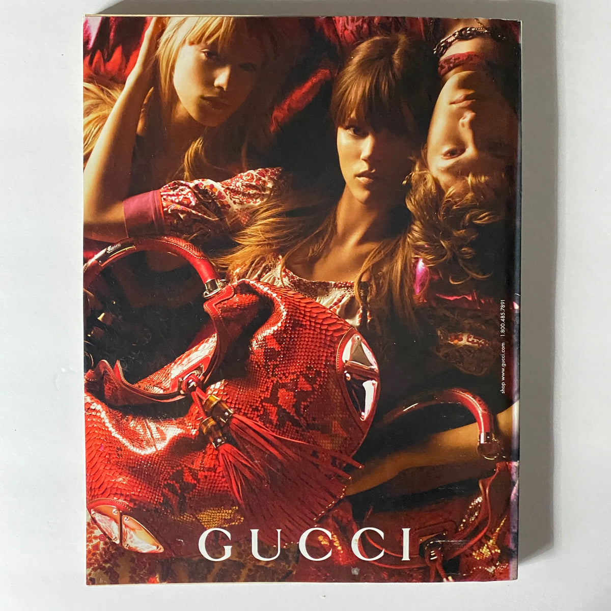 W Magazine April 2007 issue displaying a captivating Gucci advertisement with models surrounded by luxurious red handbags, embodying high fashion and glamour of the era.