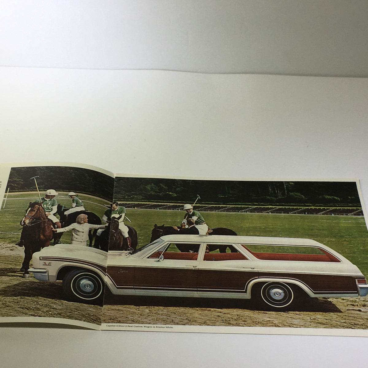 Interior view of the 1966 Chevrolet Wagon-Going Caprice 4-Door 2-Seat Wagon Catalog Brochure featuring an outdoor scene with horses and riders.