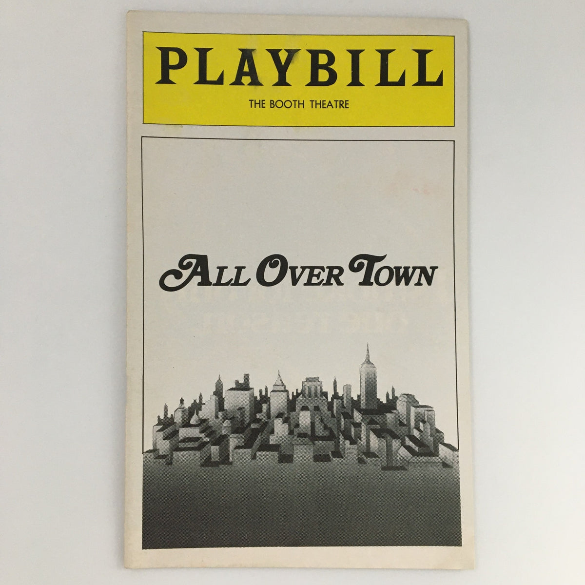 1975 Playbill for All Over Town at the Booth Theatre featuring a skyline illustration, capturing the essence of vintage New York City theater.