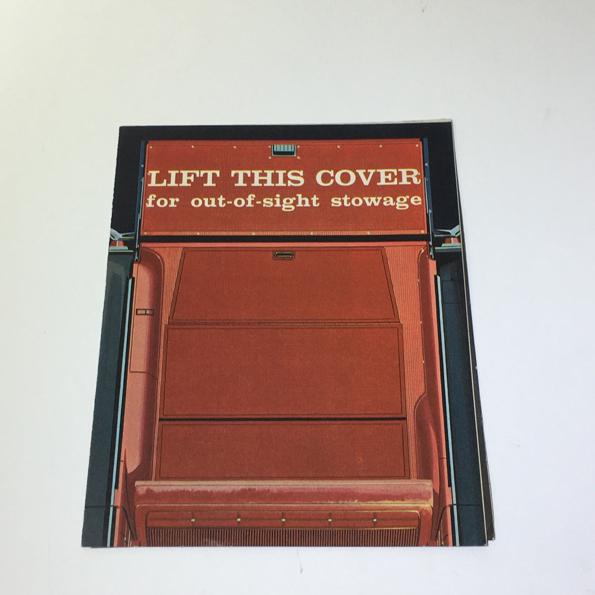 Cover image of the 1962 Chevrolet Wagons Impala 6-Passenger Wagon Greenbrier De Luxe Sports Catalog featuring an illustration that invites readers to lift a cover for out-of-sight stowage.