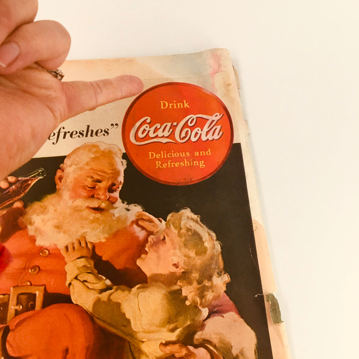 Close-up of the Coca-Cola advertisement on the back cover of the vintage Collier's Magazine from December 3, 1938. Emphasizes branding and nostalgia associated with classic holiday imagery.