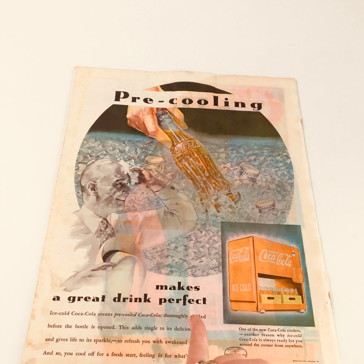 Close-up of a vintage Coca-Cola advertisement about pre-cooling drinks. This illustration is from the VTG Collier's Magazine July 14, 1934 edition, which includes 'The Crime of Communist' by G.K. Chesterton.