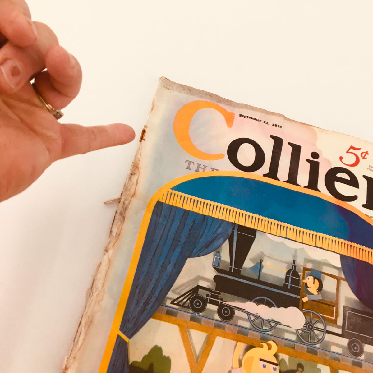 Close-up view of the cover of VTG Collier's Magazine September 21 1935 highlighting the title with a hand pointing at the edge, showing the magazine's vintage condition and wear.