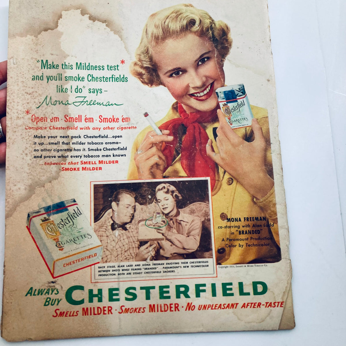 Vintage advertisement for Chesterfield cigarettes in the VTG Look Magazine January 2 1951 Vol 15 No. 1, featuring a smiling woman promoting cigarette consumption with a nostalgic flair.