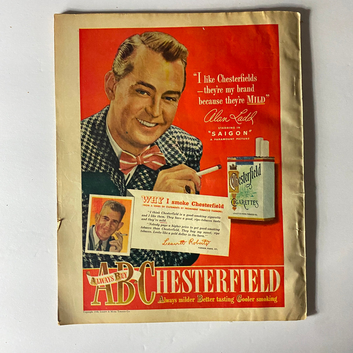 Vintage advertisement for Chesterfield cigarettes featuring Alan Ladd promoting the brand in the June 1948 Sport Magazine.