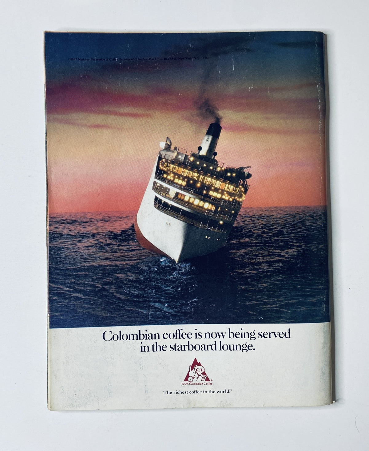 Back cover of The New Yorker Magazine December 28, 1987, showcasing an advertisement for Colombian coffee with a ship in the background, designed by L. S. Johnson.
