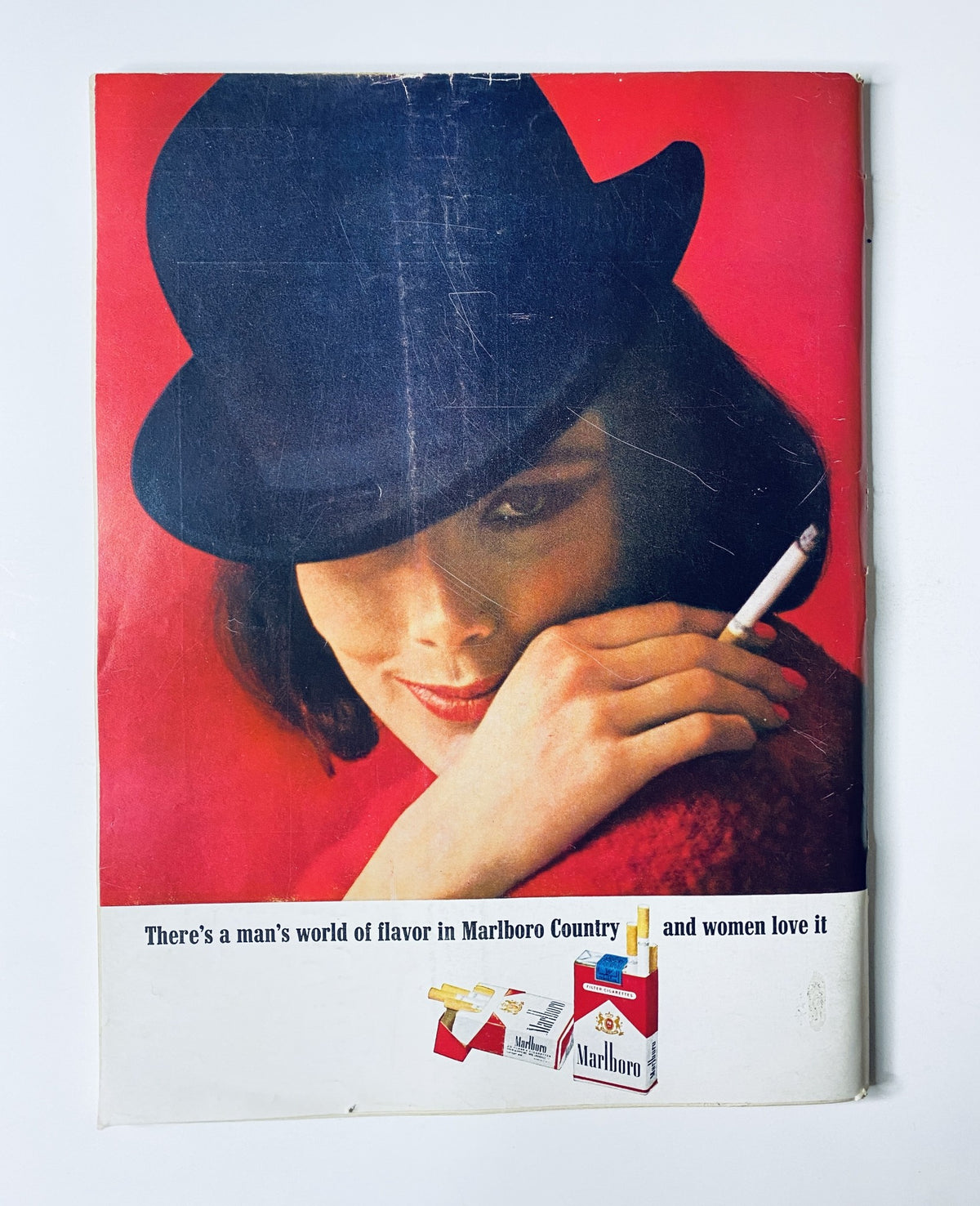 Vintage advertisement featuring a woman in a black hat and a cigarette, promoting Marlboro cigarettes from The New Yorker Magazine November 2, 1963 Halloween Witches Cover by C. Addams.