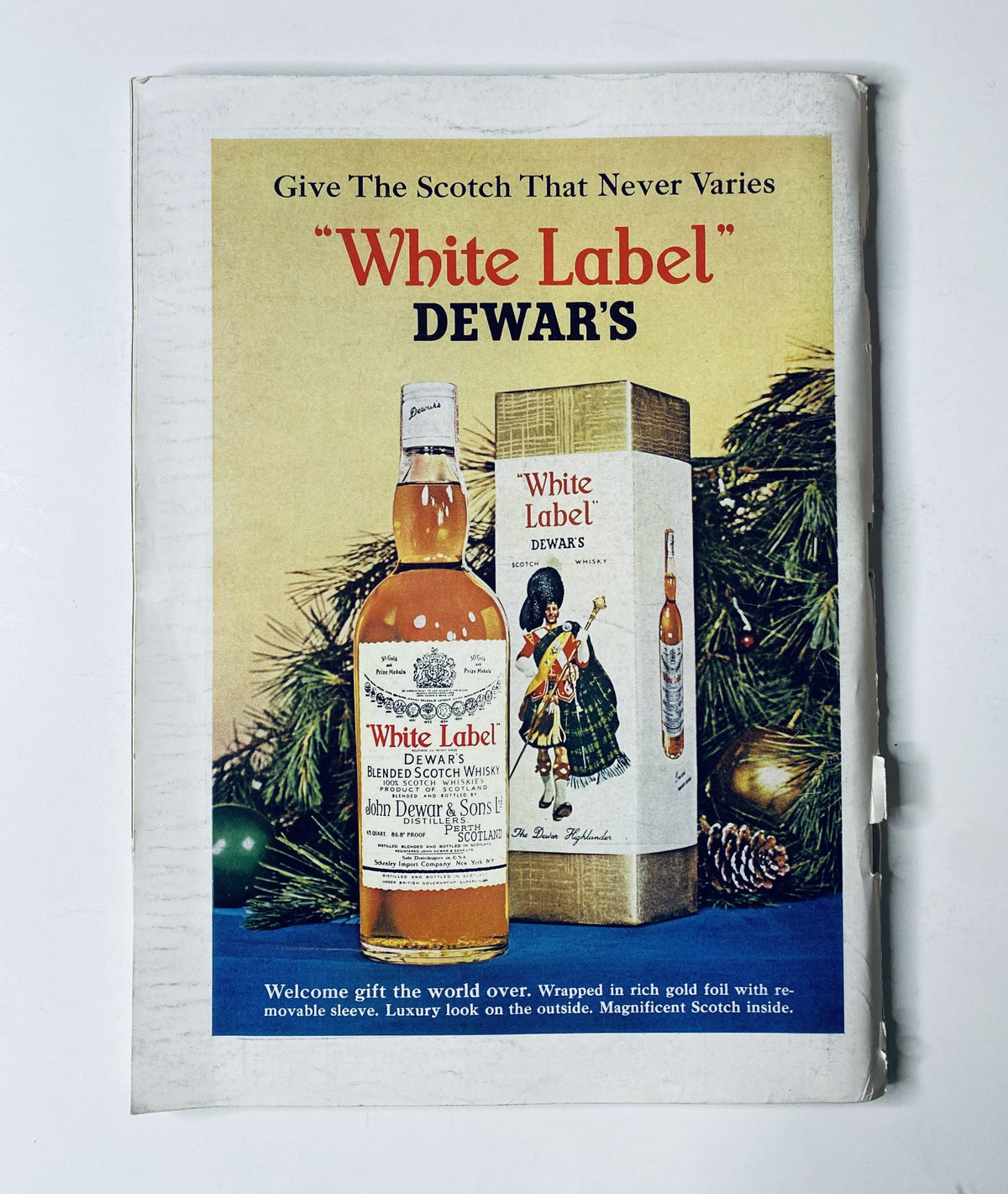 Advertisement for Dewar's White Label Scotch featuring a bottle and gift packaging, promoting the scotch as the perfect gift. The image is from The New Yorker Magazine, November 7, 1964, with an abstract line cover by Abe Birnbaum.