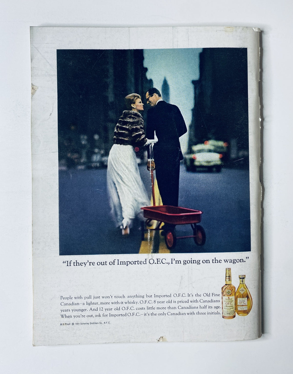 Back cover of The New Yorker Magazine October 24, 1964 featuring an advertisement for Imported O.F.C. whiskey with a stylish couple in an urban setting.