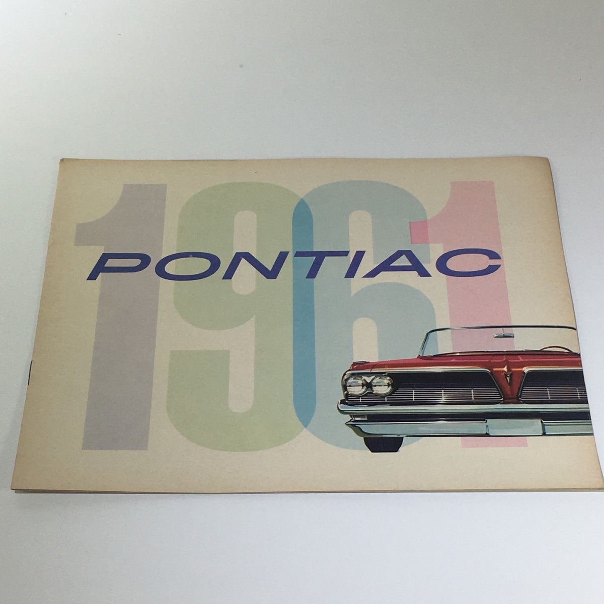 Pontiac 1961 Catalina 6 to 9-Passenger Safari Wide-Track Car Catalog Brochure cover featuring bold typography and a vintage car illustration.