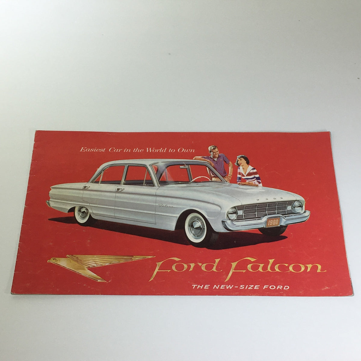 1960 Ford Falcon brochure featuring the stylish four-door design and vibrant red cover, highlighting its 90-HP 144CU Falcon Six specifications, a nostalgic piece of American automotive history.