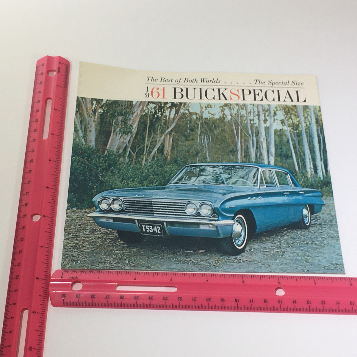 1961 Buick Special New Size 4-Door Sedan and Station Wagon Car Catalog Brochure cover displayed next to a ruler, highlighting its dimensions and classic design.