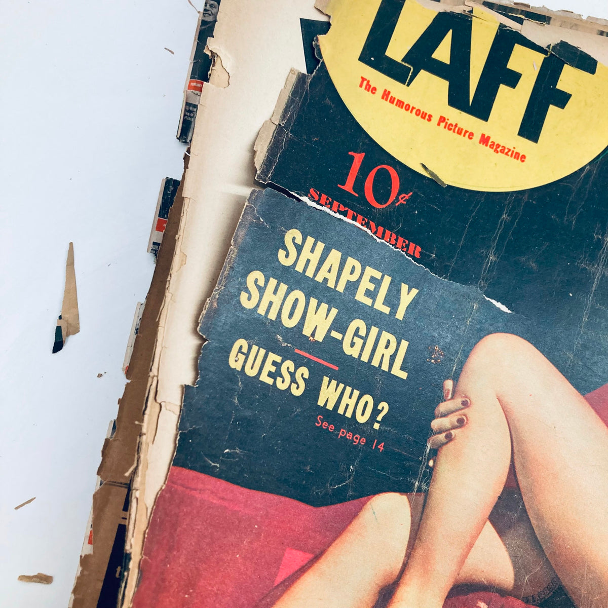 Close-up of the cover text on VTG Laff Magazine September 1942, emphasizing the phrase 'Shapely Show-Girl Guess Who?' in bold typography.