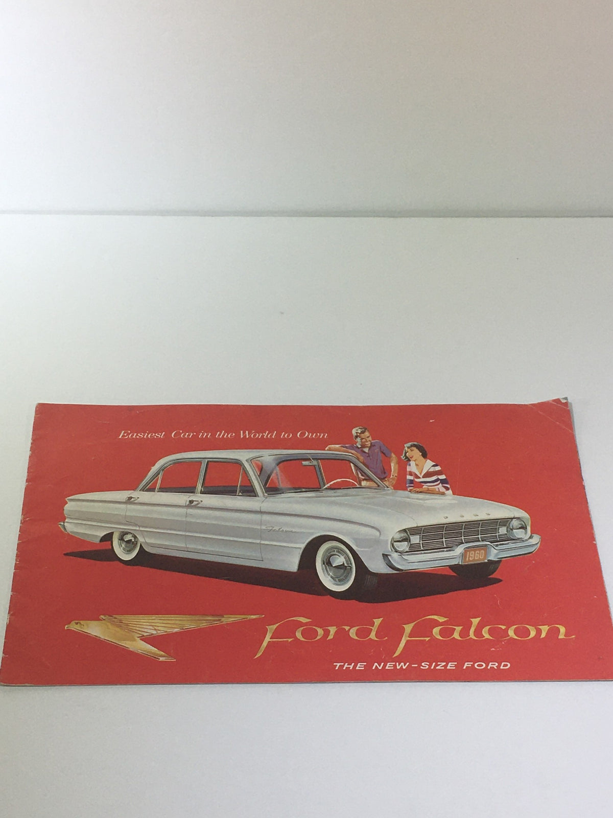 Cover of Vintage 1959 Ford-Falcon The New-Size 2-Door Ford 90-HP V-6 Car Catalog Brochure featuring a classic Ford Falcon on a vibrant red background.