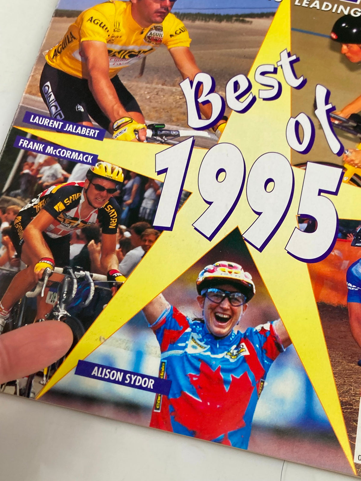 Close-up of the cover of Winning Bicycle Racing magazine, showcasing Laurent Jalabert, Frank McCormack, and Alison Sydor, with the text 'Best of 1995' prominently displayed.