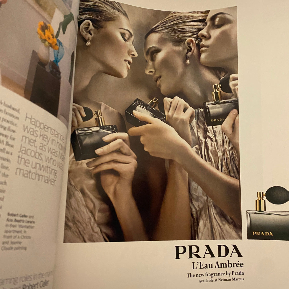 Advertisement for Prada perfume in W Magazine November 2009. Features elegantly styled models holding the fragrance in artistic poses.