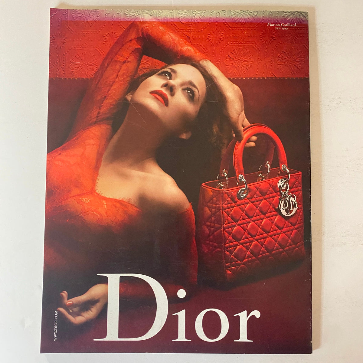 W Magazine January 2010 featuring Jennifer Garner, presenting a striking Dior advertisement featuring a model in a red dress, posing elegantly with a red Dior handbag.
