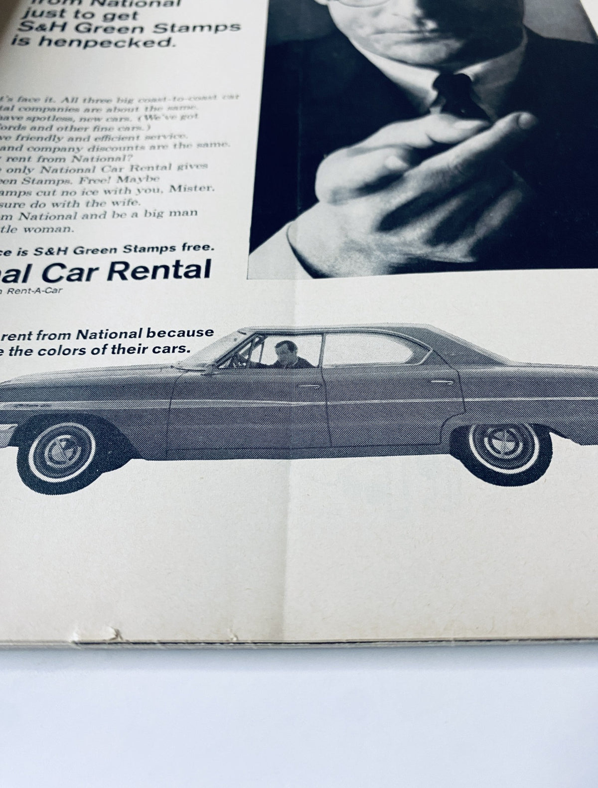 Advertisement in The New Yorker Magazine for National Car Rental featuring a classic car and a man, highlighting the car rental service's promotional offer.