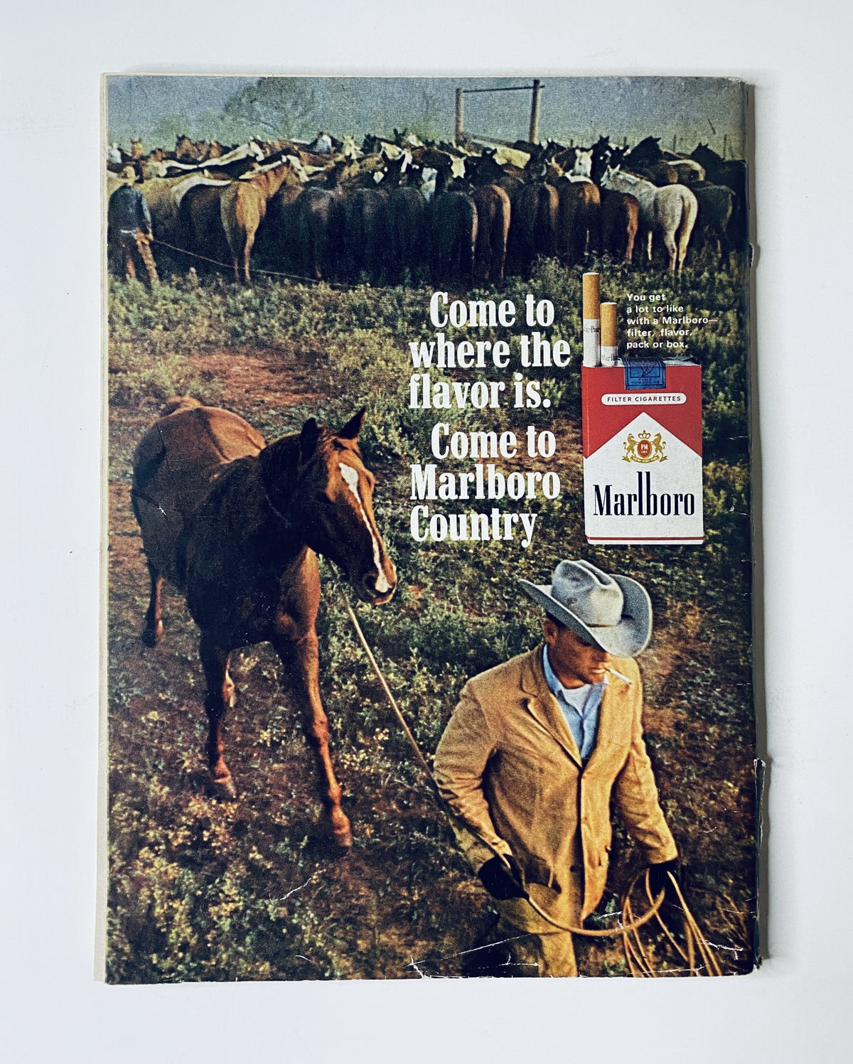 Advertisement from The New Yorker Magazine March 20, 1965, featuring a Marlboro cigarette ad with a cowboy and horses, promoting Marlboro Country.