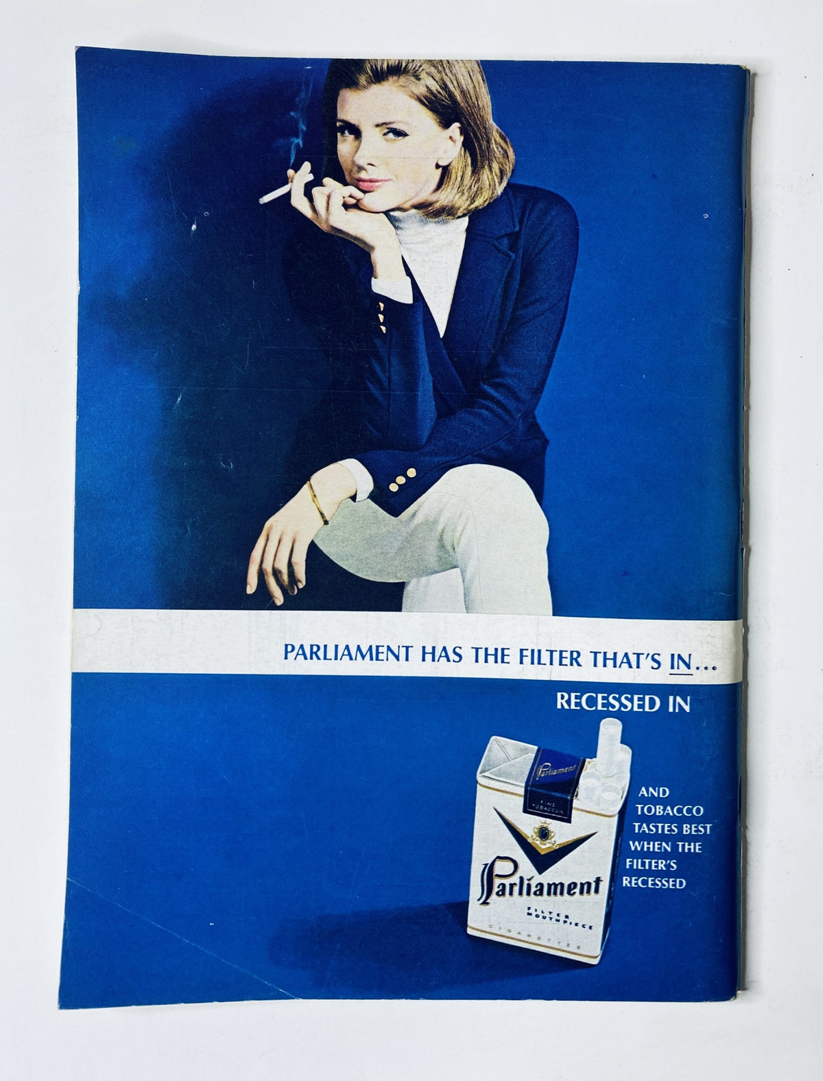 Advertisement from The New Yorker Magazine June 12, 1965 for Parliament cigarettes, featuring a stylish woman in a blue background promoting the product.
