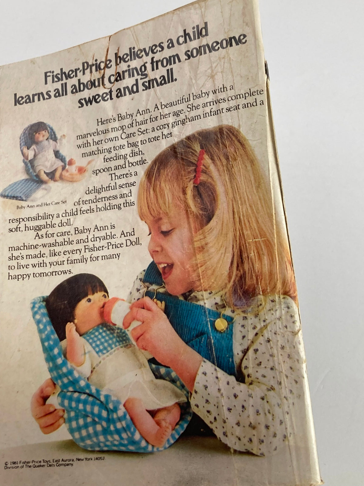 Vintage advertisement featuring a young girl playing with Fisher-Price Baby Ann doll and care set, promoting nurturing play, from the VTG Soap Opera Digest October 27 1981 Michael Minor and Susan Lucci issue.