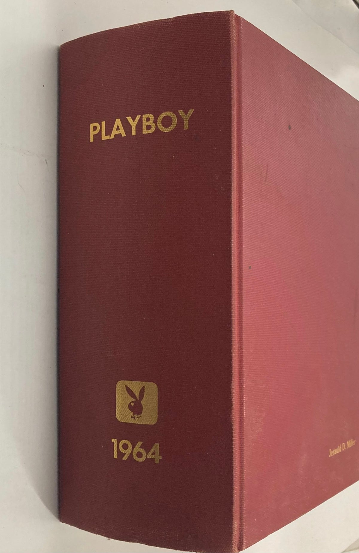 Side view of Complete 1964 Original Playboy Magazine January-December Bound showcasing the iconic Playboy logo and year 1964 embossed in gold.