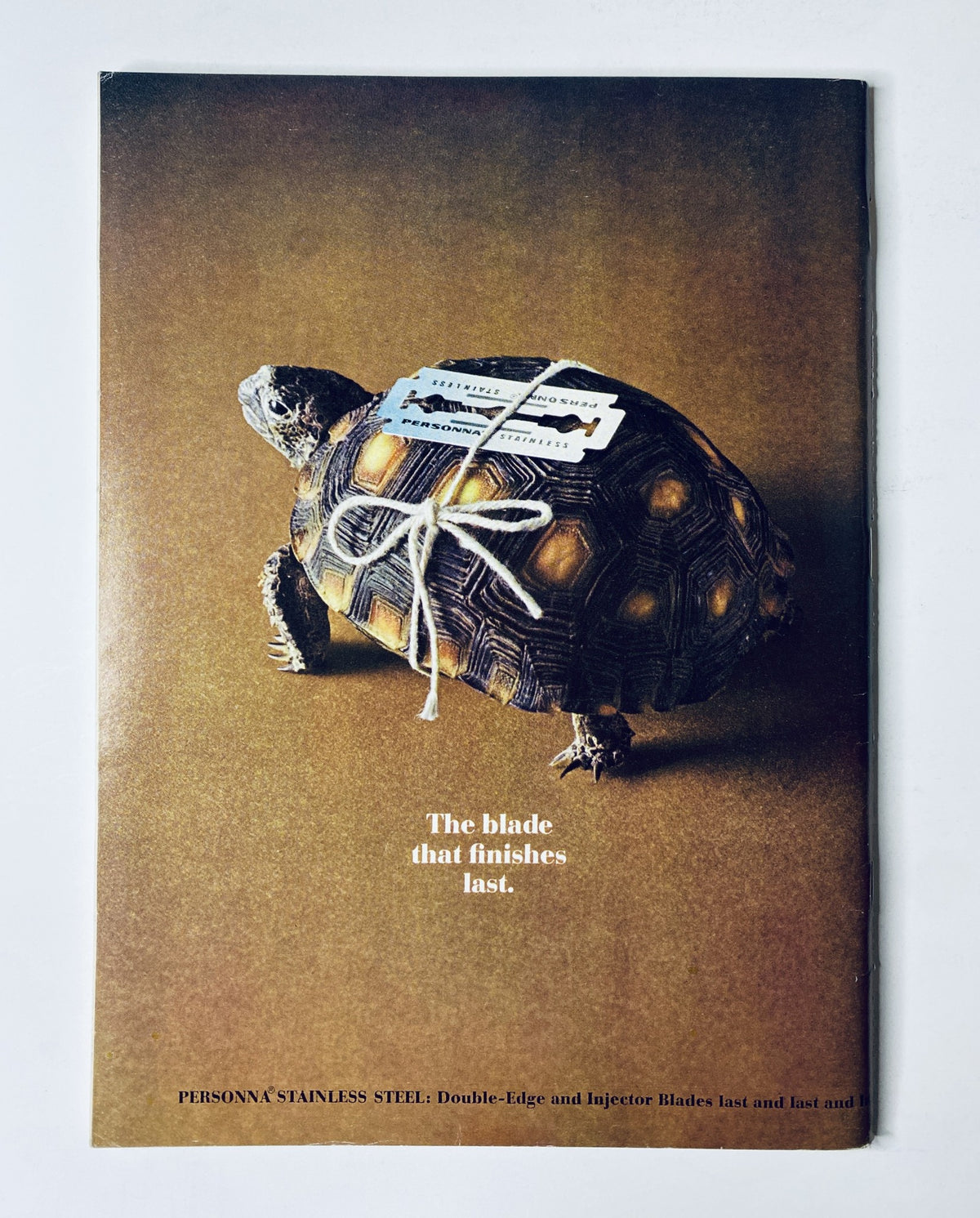 Advertisement for Persona Stainless Steel razor blades found in The New Yorker Magazine, February 19, 1966, featuring a tortoise tied with a tag, emphasizing durability.