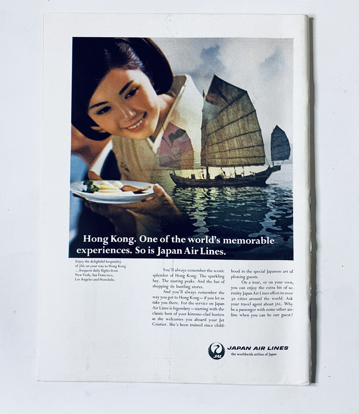 Vintage advertisement for Japan Air Lines in The New Yorker Magazine July 20, 1968, featuring a woman enjoying a meal with a sailboat in the background.