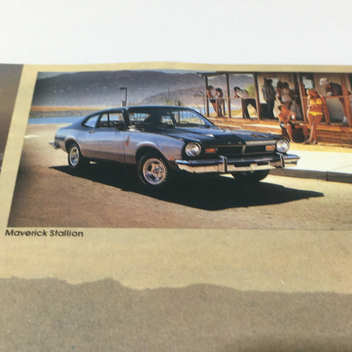 Vintage Free Wheelin' Mustang II MPG 2+2 Stallion - 1965 Shelby Cobra Car Brochure featuring a blue Maverick Stallion parked by the beach, showcasing classic automotive design.