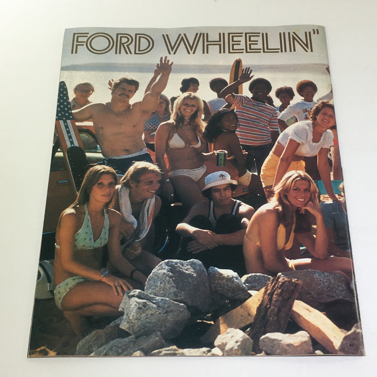 Vintage Free Wheelin' Mustang II MPG 2+2 Stallion-1965 Shelby Cobra Car Brochure cover featuring a vibrant beach scene with diverse individuals enjoying a summer day.
