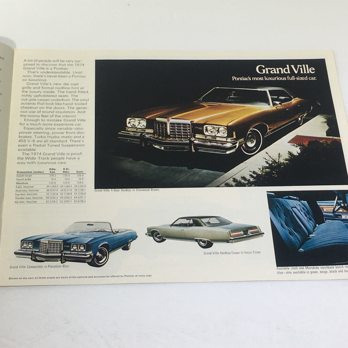 Inside view of the 1974 Pontiac Grand Ville Auto Catalog showing the luxurious Pontiac Grand Ville, showcasing various models including the convertible and hardtop editions.