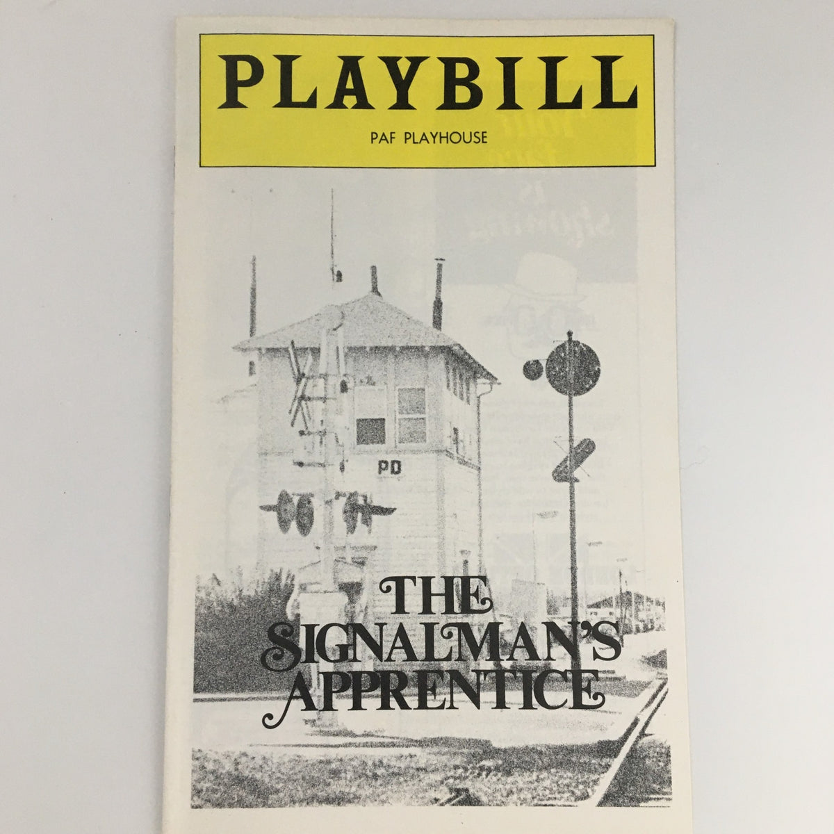 1976 Playbill PAF Playhouse 'The Signalman's Apprentice' featuring a cover image of a scenic railroad tower and sign.