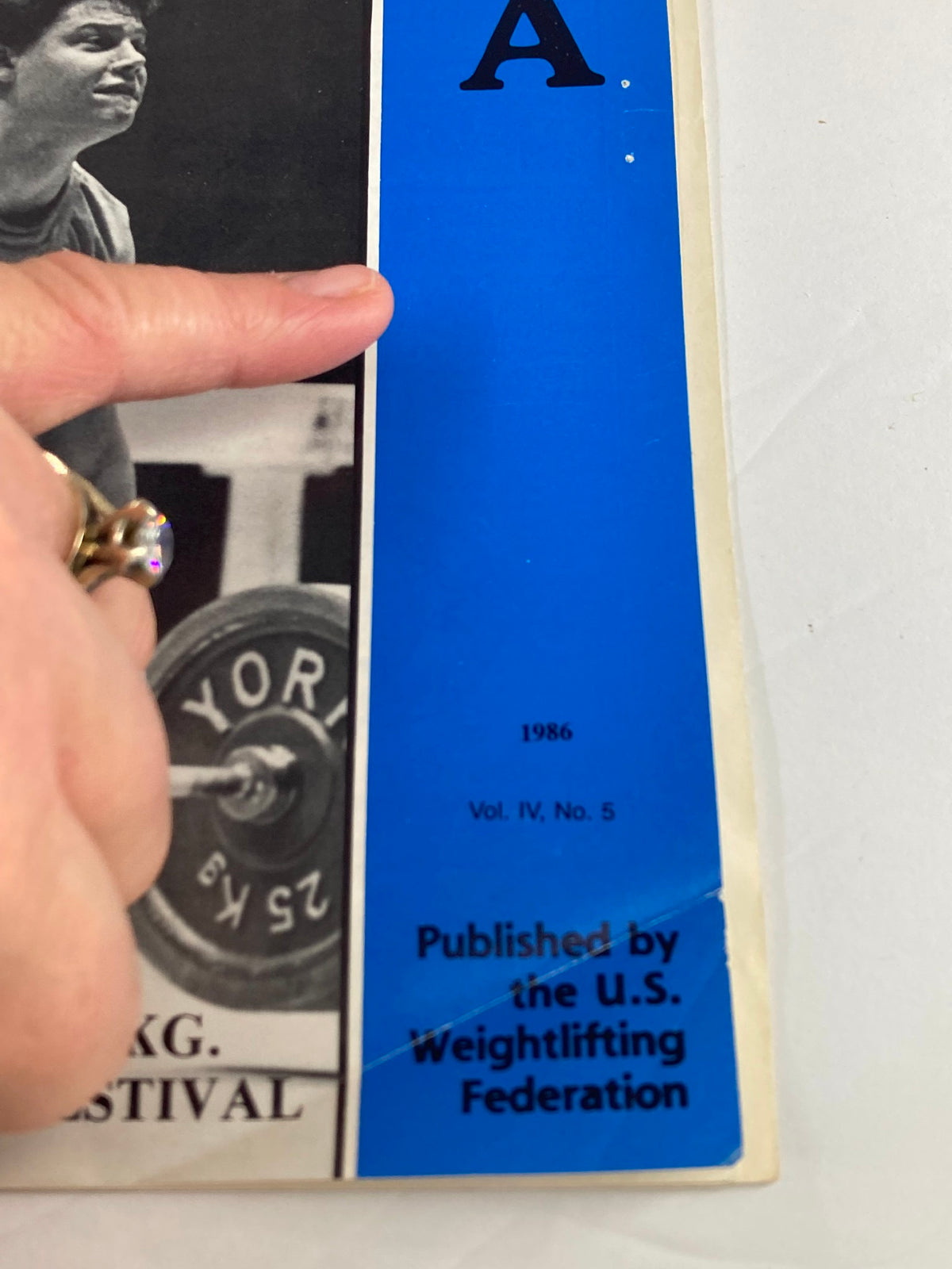 Side view of the VTG Weightlifting USA Magazine 1986 Vol 4 #5 showing its publication details and Rich Schutz, who won the Gold Medal in the 100 kg category.