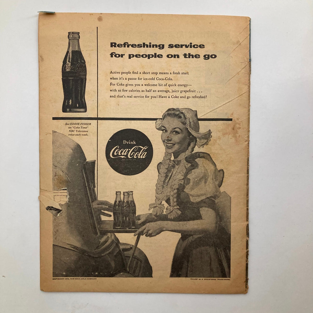 Back cover of VTG Junior Scholastic Magazine October 20, 1954, displaying a vintage Coca-Cola advertisement with a smiling woman, representing mid-20th century marketing.