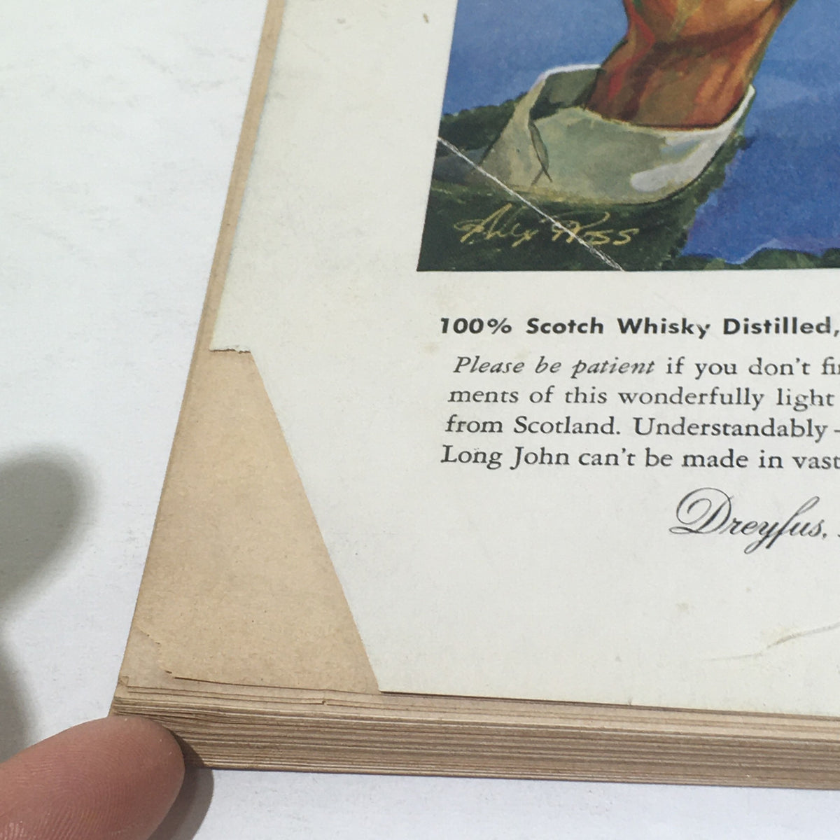 Close-up view of the bottom section of The New Yorker: October 4 1958 magazine showing the vintage advertisement for 100% Scotch Whisky and some wear on the pages, highlighting its collectible nature.