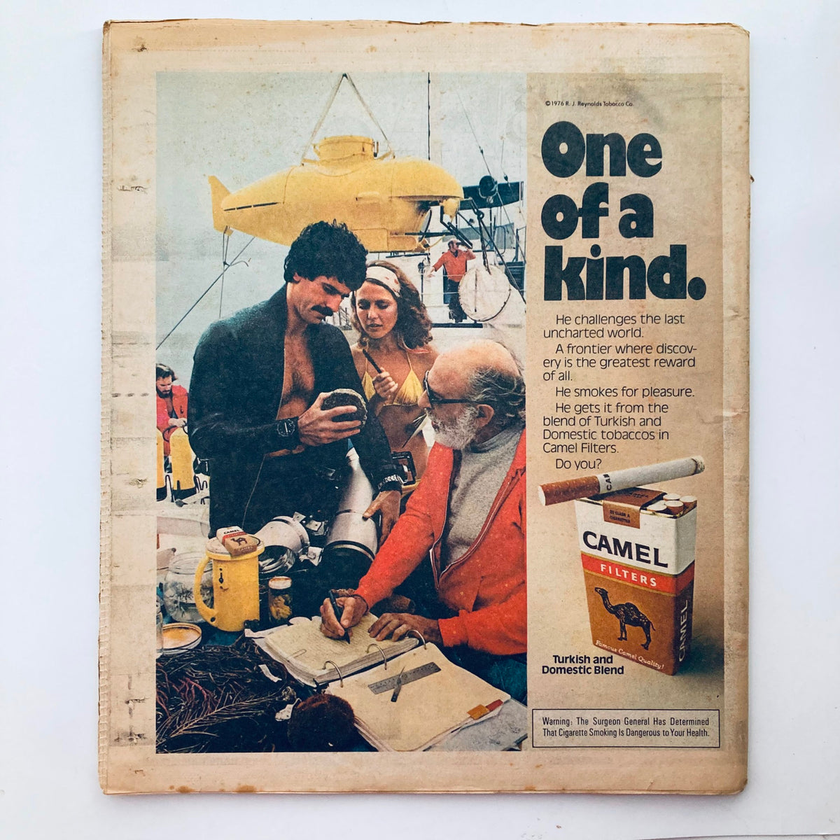 Back cover of Rolling Stone Magazine November 3 1977 Issue 251, featuring an advertisement for Camel Filters, depicting a diving scene with a group of people on a boat.