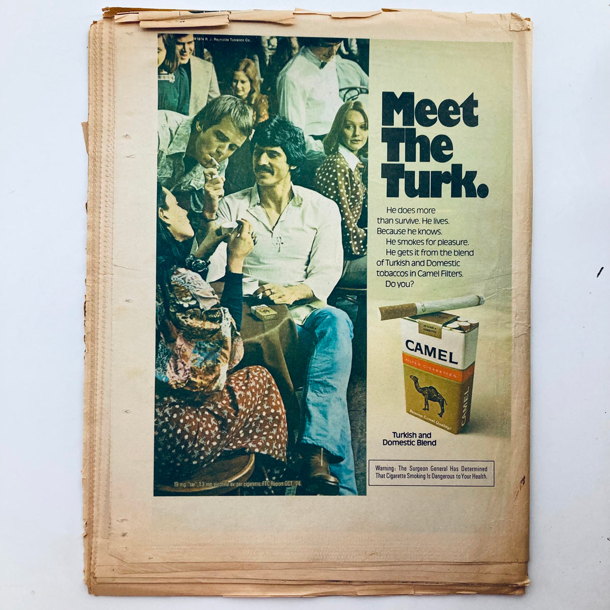 Advertisement page from Rolling Stone Magazine May 22 1975 Issue promoting Camel cigarettes with the slogan 'Meet The Turk' and featuring a group of people.