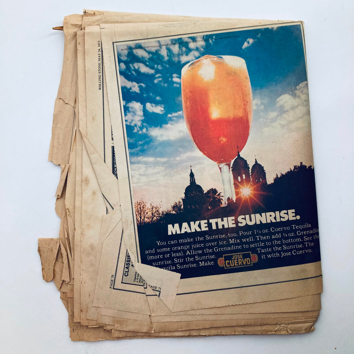 Vintage Rolling Stone Magazine May 24 1973 Issue 135 featuring an advertisement page promoting a cocktail recipe for a Tequila Sunrise with a scenic background.