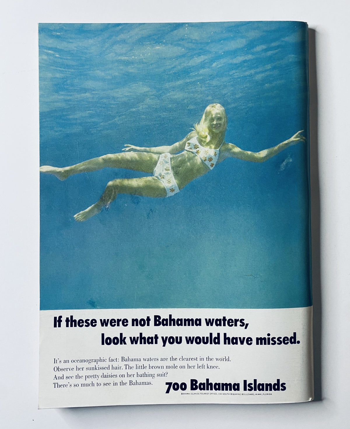 The New Yorker Magazine December 7, 1968 advertisement for the Bahamas, showcasing a woman swimming underwater with the caption 'If these were not Bahama waters, look what you would have missed.' highlights the allure of the Bahamas as a travel destination.