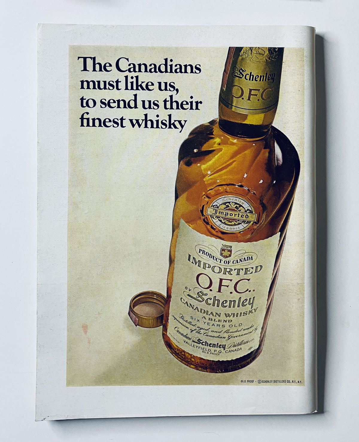 Advertisement from The New Yorker Magazine showcasing a bottle of Schenley Imported Canadian Whisky with the caption about Canadians.