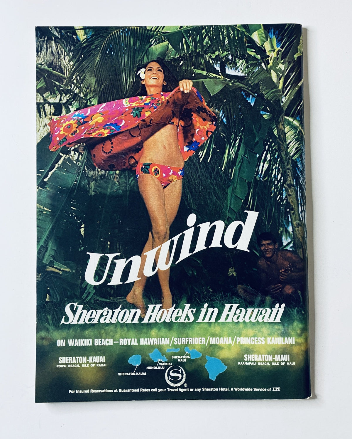 Promotional cover for Sheraton Hotels in Hawaii, featuring a woman in a colorful outfit amidst tropical scenery.