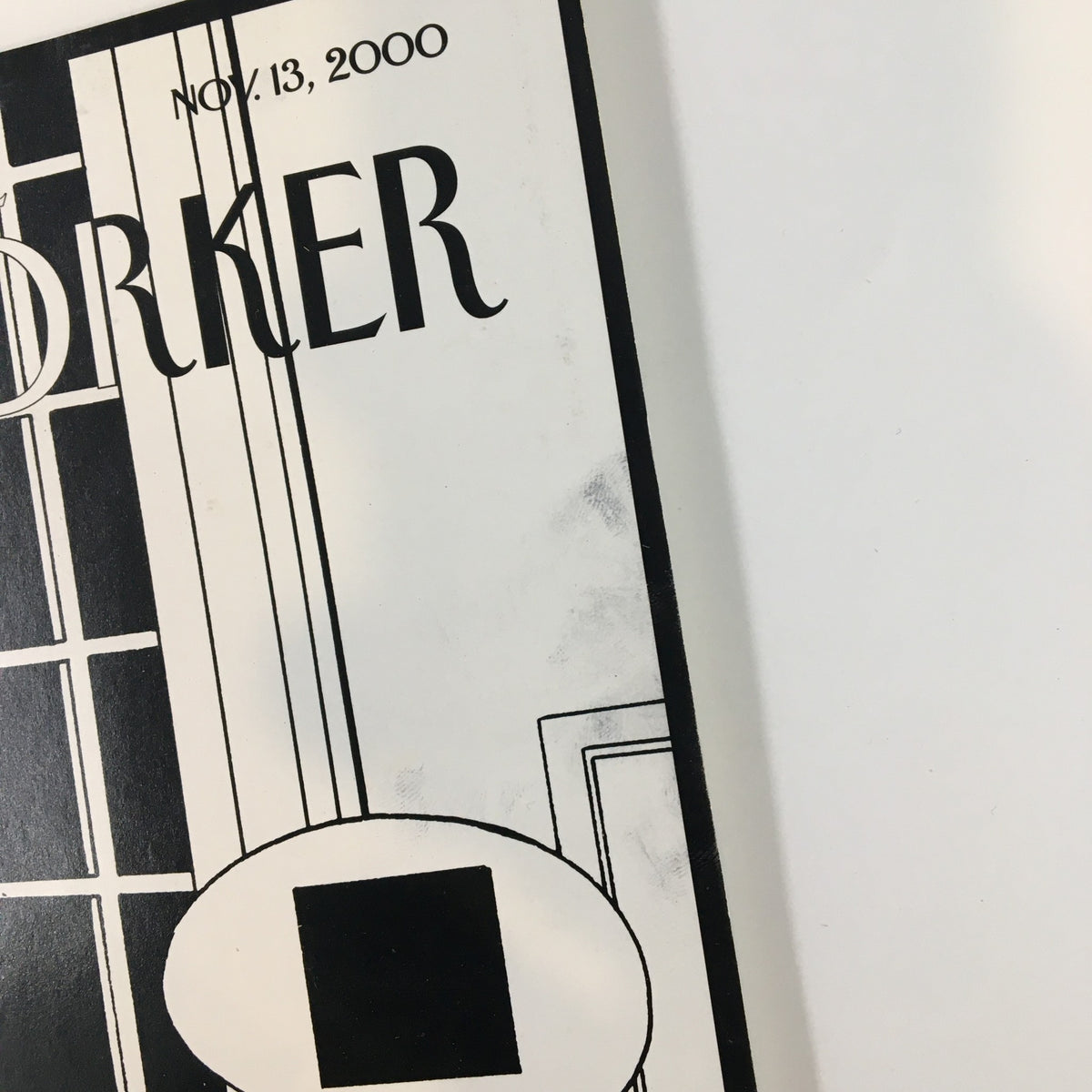 Close-up view of the cover of The New Yorker magazine, dated November 13, 2000, highlighting the title and elements of the design, including minor wear marks.